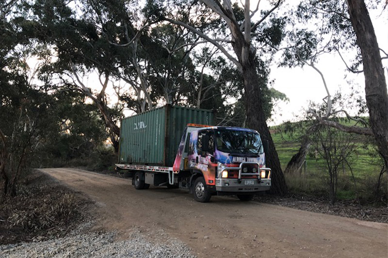 A shipping container that has been hired being delivered by an Aldinga towing truck