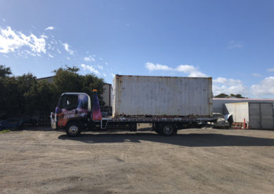 A shipping container that has been hired being delivered by an Aldinga towing truck