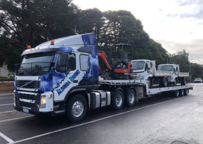 Large Tilt tray truck transporting an excavator and two tip trucks in Adelaide