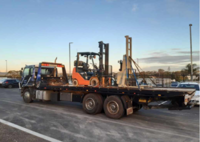 Heavy tow truck towing two forklifts at Wingfield